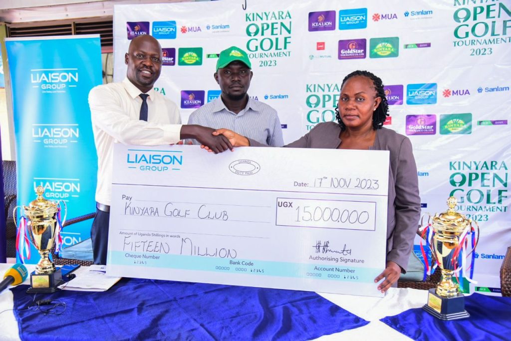 Sarah Siryowe, the General Manager of Liaison Uganda (right) hands over a dummy cheque to Kinyara representatives