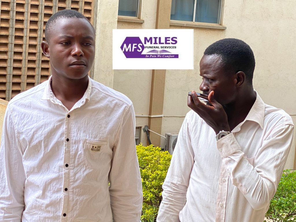 Suspects (Robert Mucunguzi , on phone and Andrew Ainomugisha) paraded shortly after being arrested at MRRH on Thursday morning.