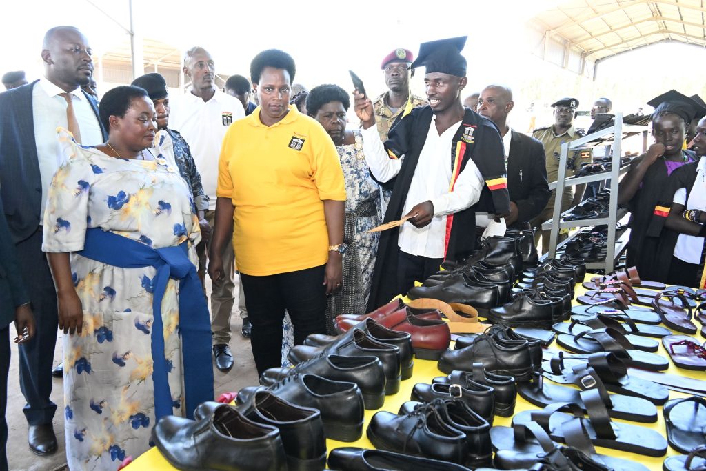 Prime Minister Robina Nabanjja (L), State House Comptroller Jane Barekye (in yellow) and other leaders inspect some of shoe products made by the youths at Bunyoro Zonal hub in Masindi district on Sunday. P