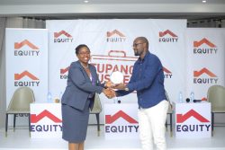 Elizabeth Kaseredde Mwerinde, Executive Director for Public Sector & Social Investments at Equity Bank Uganda hands over an Award to an SME Customer during the SME Engagements in Mbarara
