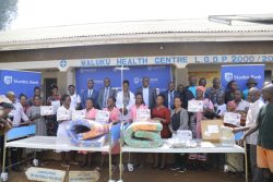 Stanbic Leadership headed by SUHL Chief Executive Francis Karunga pose for a group photo with stakeholders at Maluku Health Canter III, in Mbale City.