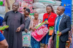 The Parish Priest of Kyarumba Catholic Parish Rev.Fr Cosmus. together with a team from Centenary Bank Kasese Branch handover the relief items.