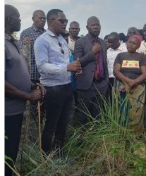 Tycoon Bulwadda flanked by Nansana RDC Shafic Nsubuga Ali (in suits) at the land which he donated to the lubigi evicted families