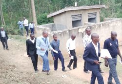 Fred Mwesigye, other stakeholders leading the team from district and minstry of health during the inspection of toilets and classrooms at Akarung PS recently