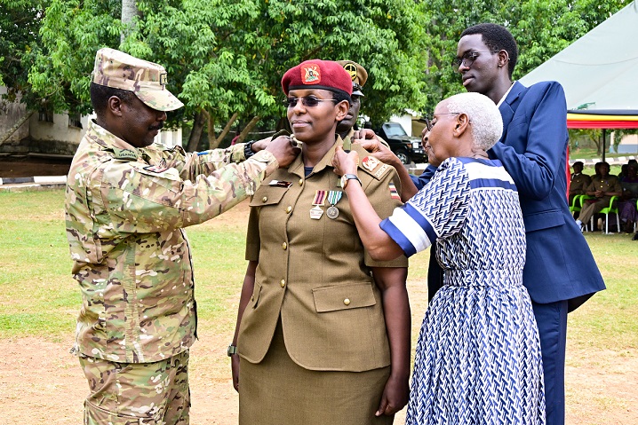 Brig General Asaf Mweteise the SFC deputy Commander pipping Lt. Col Betty Agaba during the pipping ceremony at Entebbe on Friday. PPU Photo.