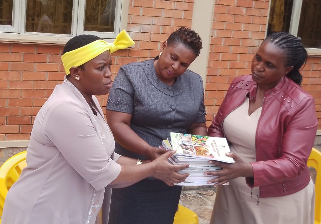 MP Rita Atukwatsa Bwahika handing over textbooks to the City Education officials 1