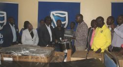 Stanbic bank MD MWOGEZA handsover to Minister Musasizi flanked by rubanda leaders