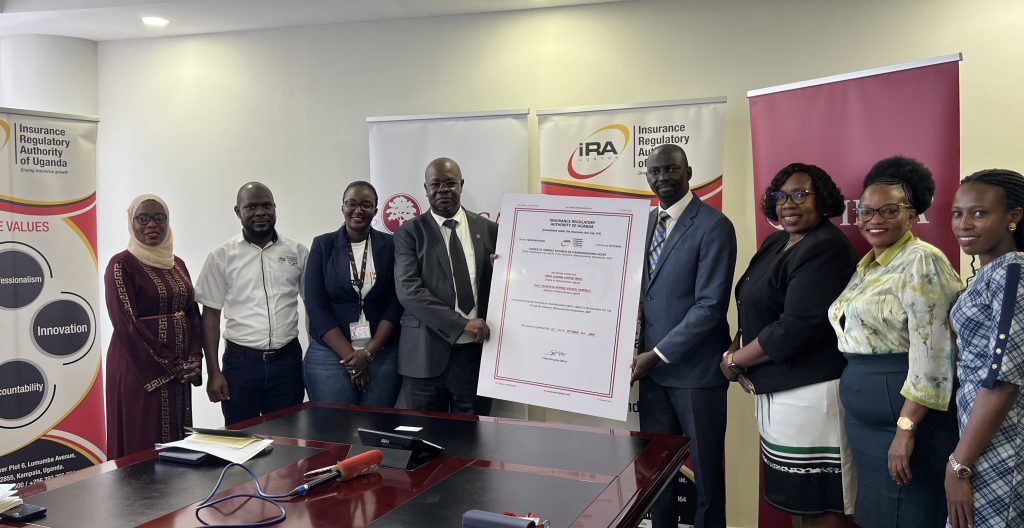James Onyutta Managing Director of FINCA Uganda, Bernard Obel, director supervision IRA and the teams from Padrepio and FINCA, IRA pose for a group photo