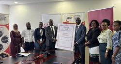 James Onyutta Managing Director of FINCA Uganda, Bernard Obel, director supervision IRA and the teams from Padrepio and FINCA, IRA pose for a group photo
