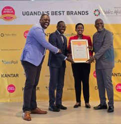Stanbic's Kenneth Agutamba (2L) recieves the award from Doreen Katusiime,the PS for Ministry of Tourism