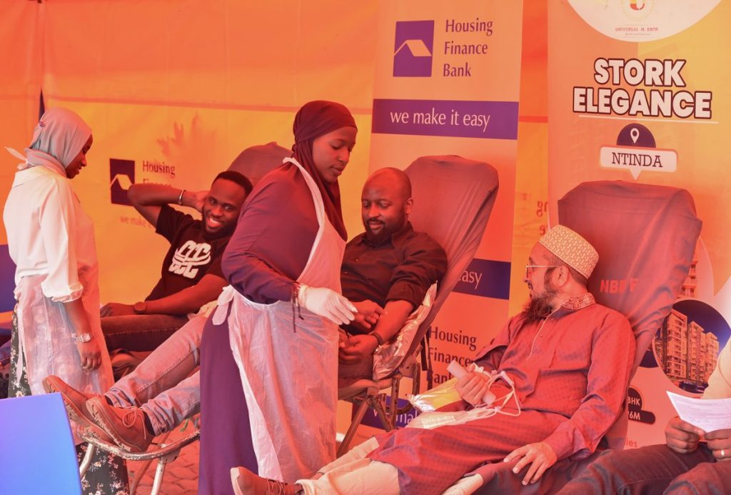 John Baptist Kaweesi-Head Mortgage and Consumer Banking at HFB and Mufaddal Yeolawala - MD Universal M. Enterprises donating blood during the drive