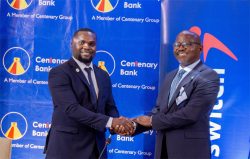 Interswitch Uganda Country General Manager, Moris Seguya (L) and Centenary Bank Managing Director Fabian Kasi (R) while announcing the partnership