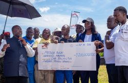 Fred Bwino Kyakulaga the State Minister of Agriculture, Animal Industry and Fisheries presents a dummy cheque of UGX 1.2b with Equity Bank’s Director of Public Sector And Social Investment Catherine P