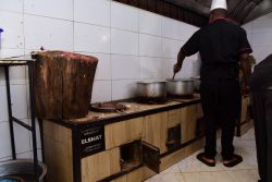 Muhuza John Bosco, Head Chef at Polland Food Centre, preparing food from the restaurants smart kitchen
