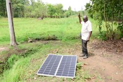 Ogwal showcasing his solar panel that powers irrigation on his farm, acquired from Tulima Solar, a partner of Equity Bank in the Resultsbased financing program