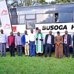 Busoga High School kamuli administration, the Equity Bank Jinja Branch manager, the Municipal Education Officer a religious leader pose for a group photo infront of the brand new bus during the hand
