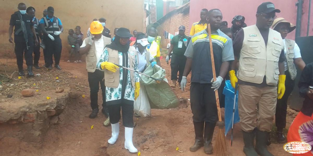 The KCCA Execute Director Hajat Sharifah Buzeki and her Deputy Benon Kigenyi during a door to door cleanup exercise in Kiwatule