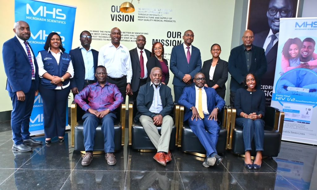 02 In the photo is Equity Banks Board Chair Henry Rugamba, MD Gift Shoko and other senior executives together with the team at Microhaem Scientific in Ntinda