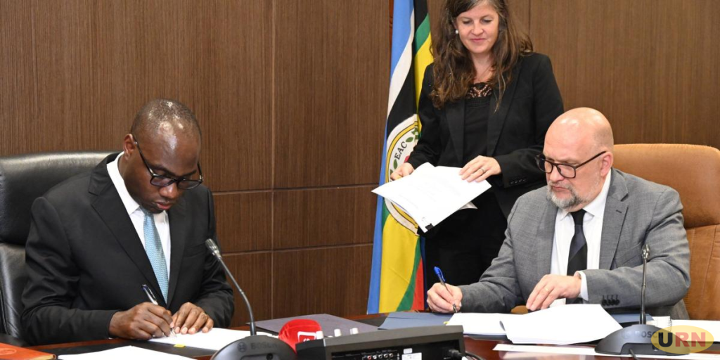 Finance Minister Henry Musasizi and the Chargé d’Affaires at the US Embassy, Mikael Cleverley signing the agreement (Internet Photo)
