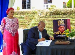 Mr. Mbire sign a condolence book at the late King's Oyo residence in Buziga, Kampala