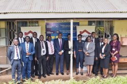 The executive leadership of the bank and the VURRA SS school administration pose for a photo after a strategic engagement in Arua district