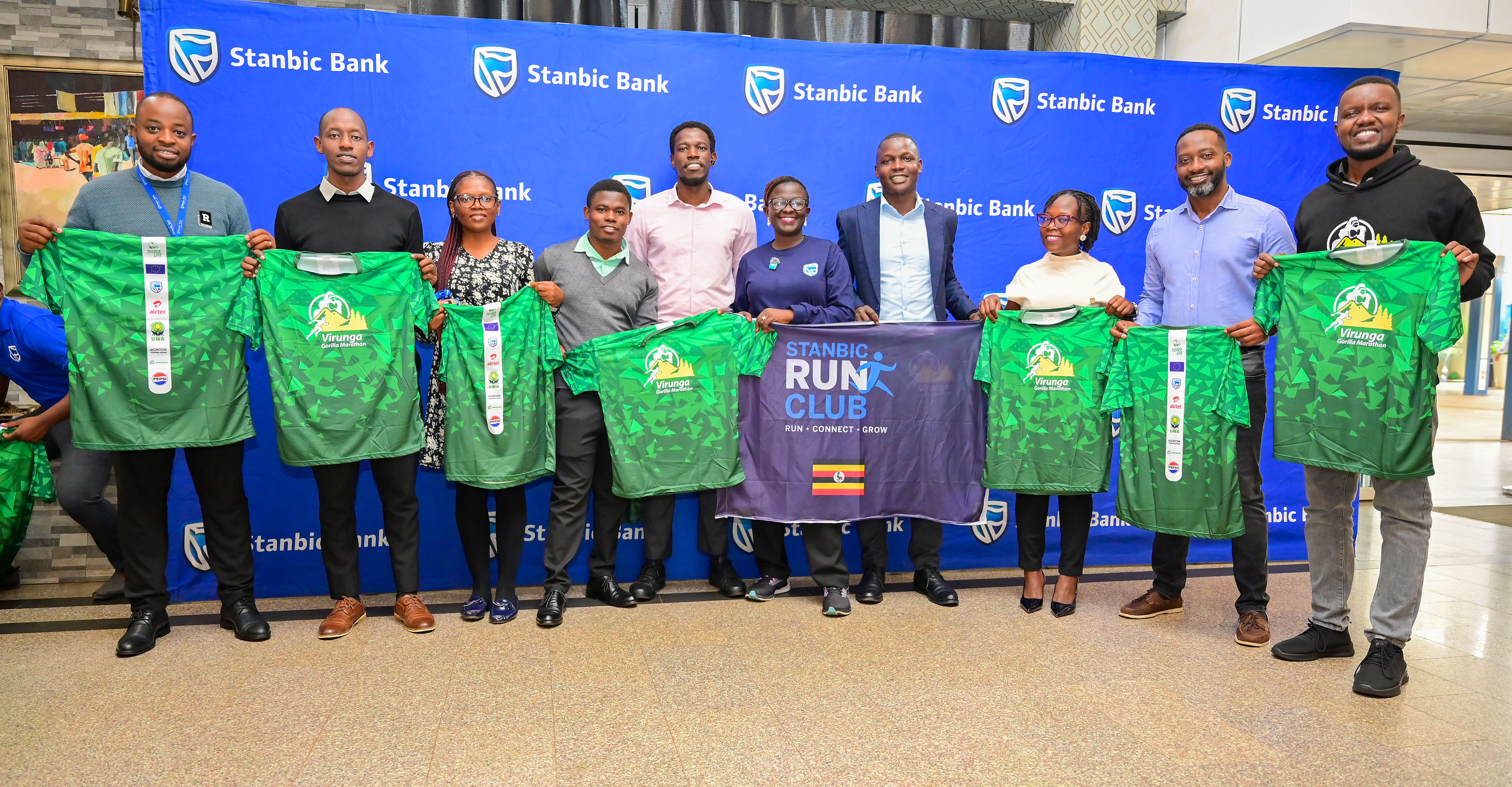 Stanbic Bank Run Club members and other officials display the Virunga Gorilla Marathon 2026 Kit